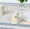 stoneware jug with handle, featuring yellow lemon design
