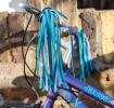 Bike streamers with blue and teal ribbons fixed in bicycle handle
