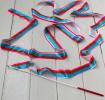 gymnastics ribbon with multicoloured stripes and red-handled stick