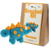 Blue crocheted dinosaur placed next to its packaging