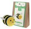 Crochet kit packaging and finished crocheted bee beside it