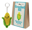 Crochet kit packaging displayed next to a finished yellow and green leaf sweetcorn keychain