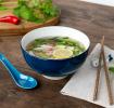 Blue ceramic noodle bowl set with spoon, chopsticks, and fish-shaped rest
