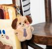 dog-shaped plush keyring wearing a tie with brown ears 