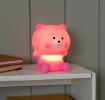 Pink teddy bear night light with light on