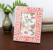 picture frame with a pink border and white leaf patterns