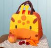 Orange lunch bag with dark brown handles and a cute giraffe face design on the front and two giraffe horns at the top