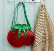 Children’s glitter handbag shaped like a red cherry, with green leaves and a green strap