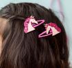 Pair of pink hair clips with glittery unicorn heads