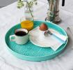 Round enamel trinket tray in aqua displayed with cup of coffee, orange juice and an egg.