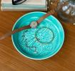 Enamel trinket dish in aqua displayed with a watch and jewellery