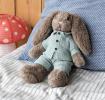 Plush bunny toy with floppy ears, wearing light green shirt and pants