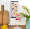 magnetic shopping list pad with dog illustrations hanging on a wall.
