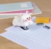 Kitten-shaped stapler with a small box of staples beside it