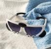 sunglasses with white snow leopard design, black spots, and dark lenses