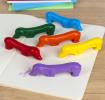 Set of six sausage dog-shaped crayons in yellow, purple, red, blue, green, and orange.