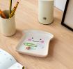 Ceramic trinket dish shaped like a slice of bread with a smiling face and pink cheeks