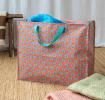 Pink jumbo storage bag with colourful floral designs.