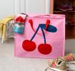 Large pink storage bag with a bold cherry graphic and red handles.