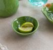 Green ceramic bowl with textured lime-like pattern and glossy finish.