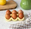 Yellow ceramic egg holder displayed with six eggs