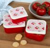 A set of three cherry‑pattern snack boxes displayed with cookies.