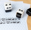 Panda-themed roller stamp with the cap removed, 