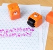 Kitten-themed roller stamp with the cap removed.