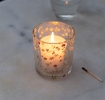 Clear glass candle holder with delicate floral design 