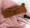 Soft and cosy headband, featuring the friendly face of a capybara. 