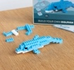 Completed dolphin brick model displayed beside its packaging box.