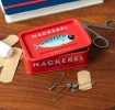 Red mini storage tin with an mackerel illustration on the front.