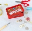 Red mini storage tin with an all spice illustration on the front.
