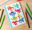 Notebook with colourful dinosaurs on a light background.