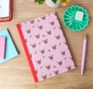 Pink notebook with a french rose design on the cover.