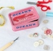 Pink mini storage tin with lid featuring lobster print