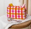 Pink and yellow gingham quilted makeup bag with a zip and tassel.