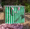 Green and pink striped jumbo storage bag with handle.