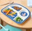 Tiger-themed toddler divider plate shown with vegetables, pretzels and peas on a wooden table.