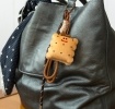 Plush toast bag charm with brown cord strap and metal clip attachment