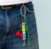 Crochet cherry bag charm with green cord strap, colourful beads