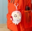 Plush toast bag charm with pink clip, pink spotty bow attached to the backpack