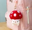 Plush mushroom bag charm with red spotted cap, gold keyring and soft white base