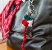 Red knotted cord keyring charm with bunny pendant, and strawberry detail.