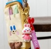 Bunny bag charm with pink outfit, silicone wrist strap and bow detail