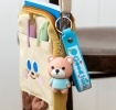 Bear bag charm with blue outfit, silicone wrist strap and silver keyring