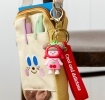 Copilot said:  Cherry girl bag charm with red cherry hat, pink outfit, silicone wrist strap and keyring