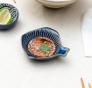 Fish-shaped blue ceramic dipping bowl shown with dipping sauce.