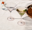 Two pink ridged martini glasses with elegant stemmed design.