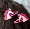 Pair of pink hair clips with glittery unicorn heads
